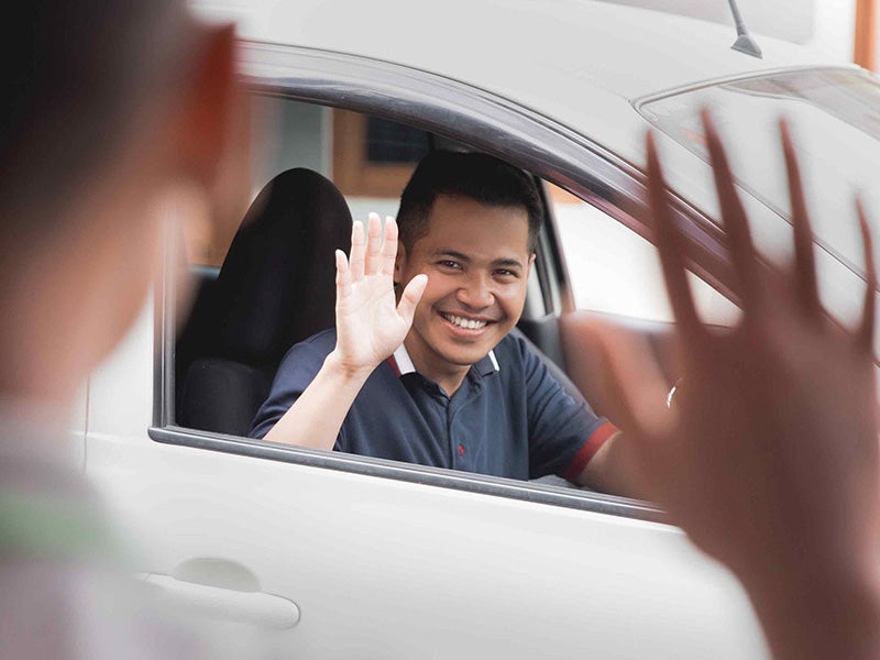 AutoNation Chevrolet Greenacres in Greenacres FL customer waving to sales rep
