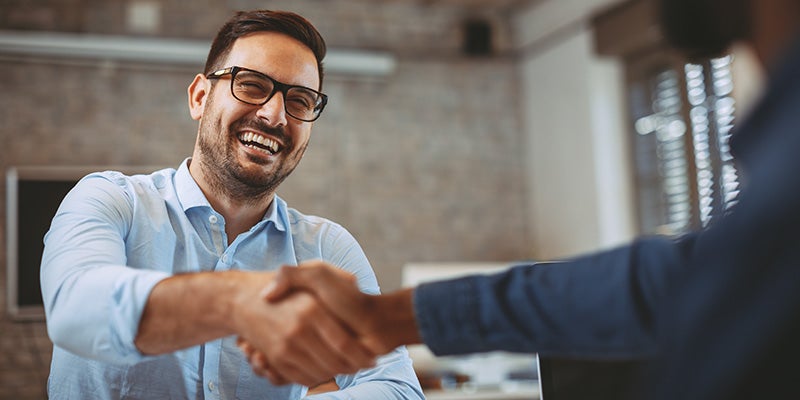AutoNation Chevrolet Greenacres in Greenacres FL customer shaking hand with sales rep